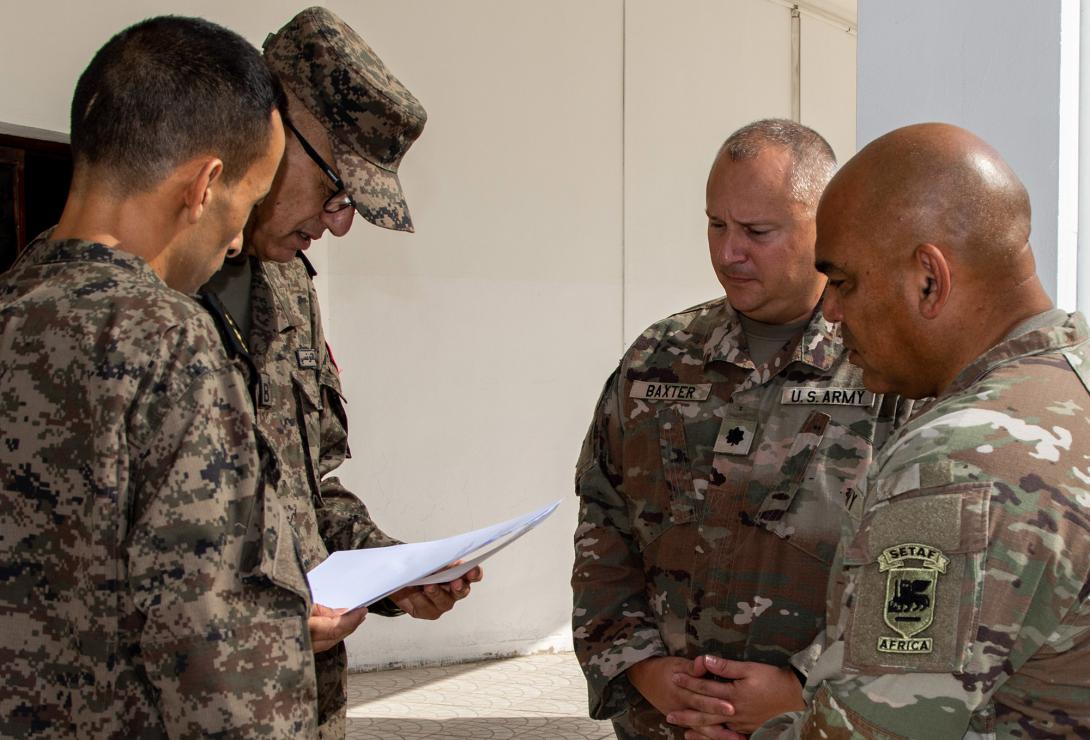 U.S. Army Maj. Jay Jackson, African Lion 2026 (AL26) Tunisia lead planner (G7) for U.S. Army Southern European Task Force, Africa (SETAF-AF) (r), reviews the minutes (a planning agreement) with Lt. Col. Corbett Baxter, African Lion lead planner (G7), SETAF-AF, and Tunisian Armed Forces Senior Col. Mguidich Mejid, exercise director for AL26, at the initial planning event for the exercise at El Aouina Air Base, Tunis, Tunisia, September 2025. U.S. Army photo by Maj. Joe Legros
