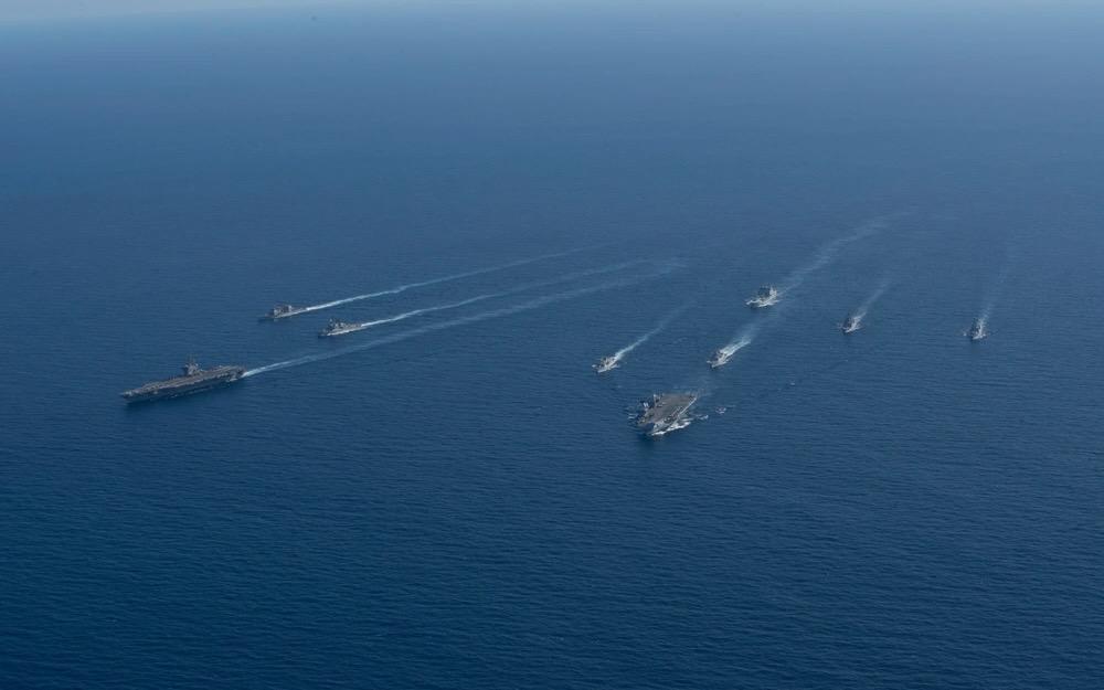 The U. K. Royal Navy HMS Prince of Wales Carrier Strike Group operates with the U.S. Navy George Washington Carrier Strike Group in the Timor Sea, as part of Talisman Sabre, July 18, 2025. Senior U.S. military leaders call for the understanding and widespread use of Allied Communications Publications 240, standards of which underpin effective operations, data sharing and network connections, amongst allies. U.S. Navy photo by Mass Communication Specialist 2nd Class Tyler Crowley