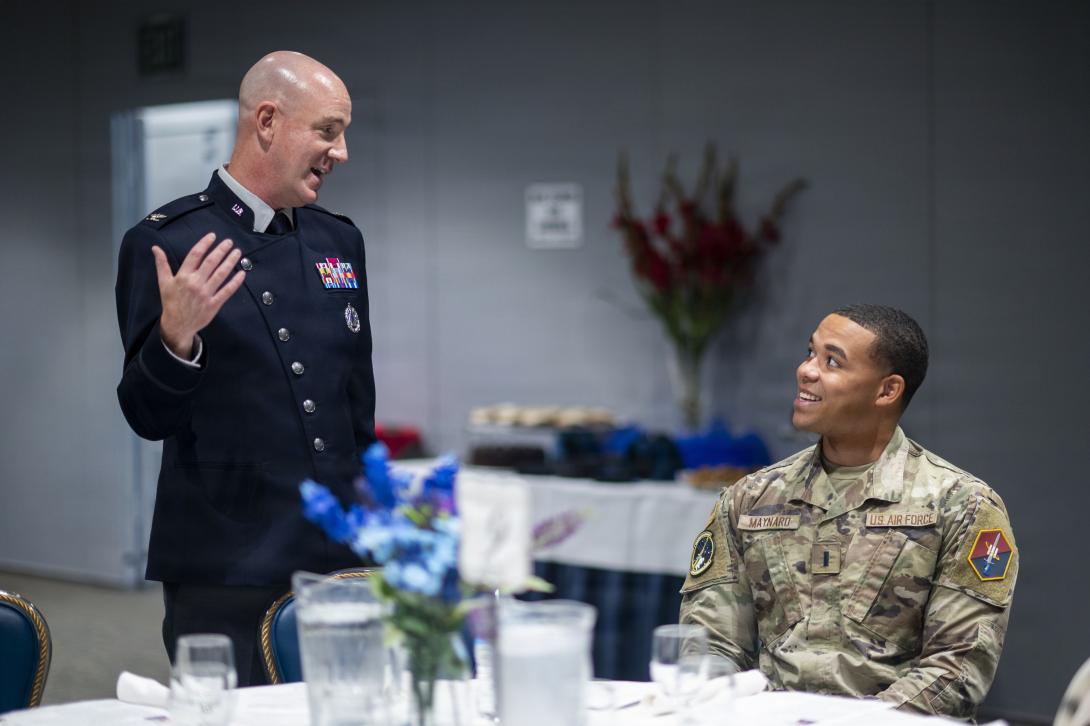 Space Force Col. Andrew Menschner, deputy commander of Space Systems Command, and Air Force 1st Lt. Dorian Maynard, officer in charge of the 61st contracting flight, Space Base Delta 3, speak during a STEM scholarship luncheon at Los Angeles Air Force Base in El Segundo, California, on Sept. 22, 2026. Credit: Van Ha