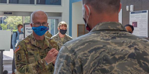 Lt. Gen. Ronald Place, USA, director of the Defense Health Agency (DHA), speaks with a U.S. Airman assigned to the 4th Medical Group at Seymour Johnson Air Force Base, North Carolina, in August. The director is leading the DHA's efforts to improve the care of warfighters, including through the use of advanced technology, where appropriate. Credit: U.S. Air Force photo by Senior Airman Kylee Gardner
