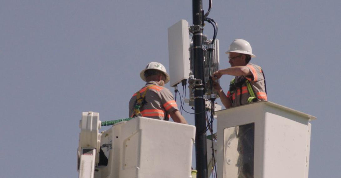 Technicians from Verizon install a 5G node in Indianapolis. The different bandwidths offered by the new cell technology offer a host of new capabilities for commercial and military users.  Verizon