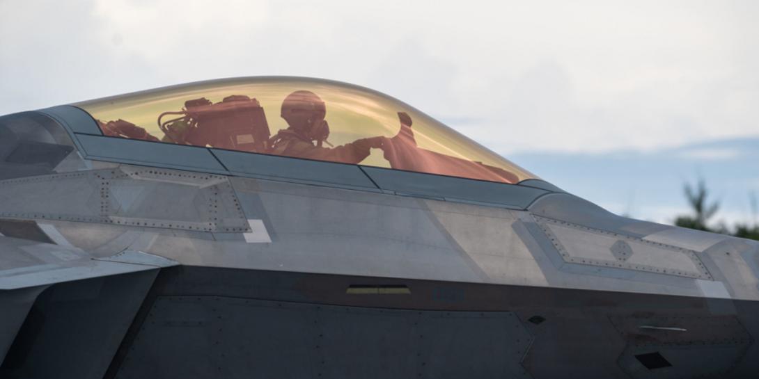 A U.S. Air Force pilot sits in an F-22 Raptor on Northwest Field, Guam, in July during Operation Pacific Iron 21. The operation increased the abilities of airmen, including fighter pilots, outside of their primary roles, as the service grows multi-capable warfighters. Credit: Air Force photo by Senior Airman Alexandra Minor.