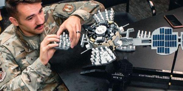 An AFRL engineer works on a Lego model of the Navigation Technology Satellite-3. The AFRL is working on advanced techniques for detecting and mitigating interference to the advanced position, navigation and timing satellite, scheduled to launch in 2022.  AFRL