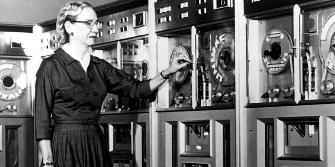 After serving in the U.S. Navy during World War II, Grace Hopper remained in the naval reserve. In 1952, her team at Remington Rand created the first compiler for computer languages, which was a precursor for COBOL. In this 1960 report, Hopper stands next to a mainframe computer that ran using COBOL. Courtesy of the Computer History Museum