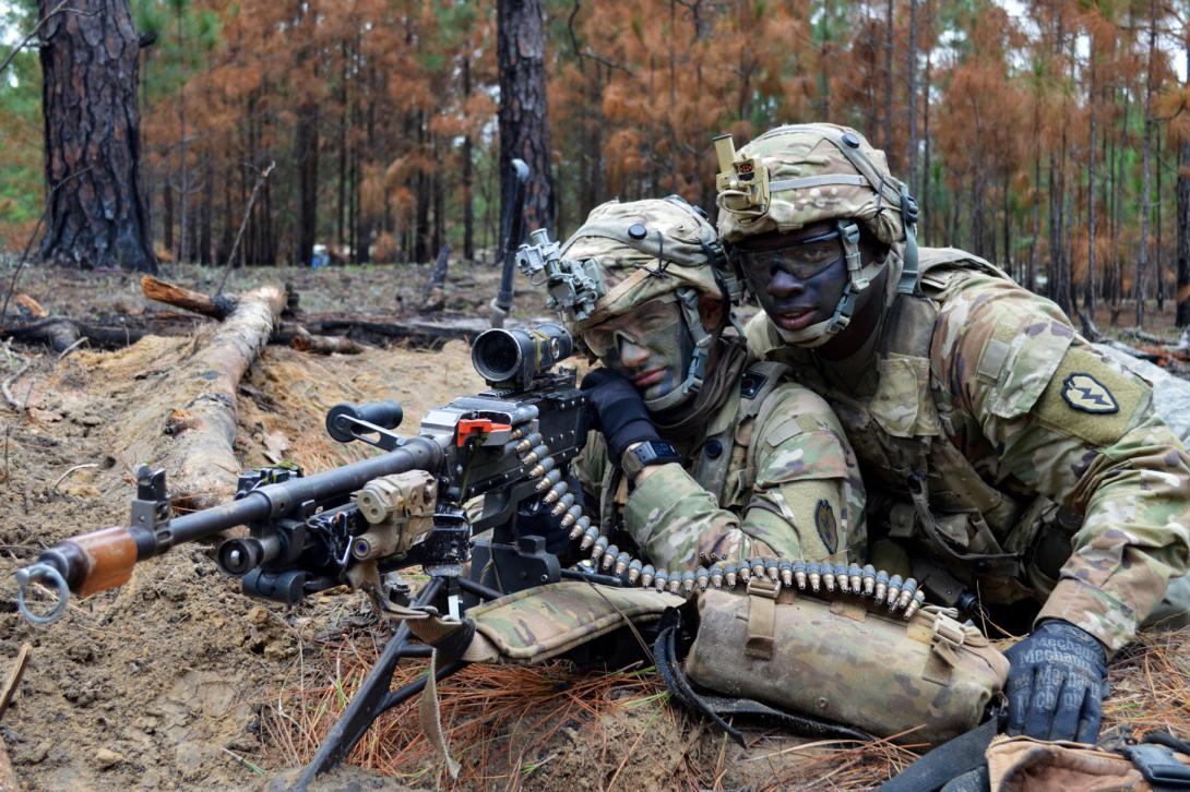 Army Spc. Hayden Harnek (l) aims an M240B machine gun as Army Spc. Josh Rowe assists during training at Fort Polk, Louisiana, on February 15. The Army is looking into lighter-weight materials, enhanced ammunition design and integrated technologies, all to increase warfighter lethality. Army photo by Staff Sgt. Armando R. Limon