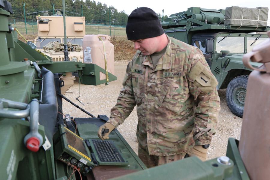 Cpl. Koty Kennedy, USA, Secure Mobile Anti-jam Reliable Tactical Terminal (SMART-T) team leader, 82nd Engineer Battalion, 2nd Armored Brigade Combat Team, 1st Infantry Division, monitors the computer system during the deployment of the system at Hohenfels Training Area, Germany. U.S. Army photo by Staff Sgt. Wallace Bonner