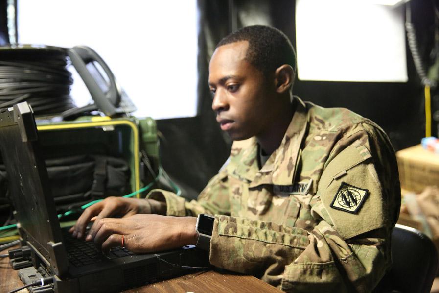 Sgt. Kino Malone, USA, 44th Expeditionary Signal Battalion, 2nd Theater Signal Brigade, monitors network communications flowing through the single shelter switch in support of the reception, staging, onward movement and integration process for regionally allocated forces deploying into and out of the European theater for Operation Atlantic Resolve. U.S. Army photo by William B. King