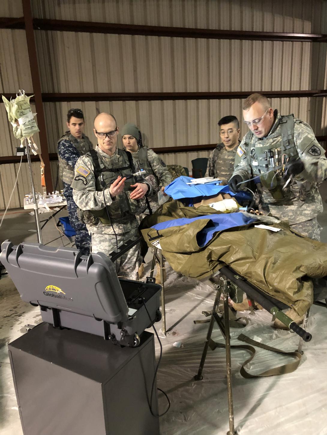 U.S. Navy photo by Mass Communication Specialist 3rd Class Cameron Pinske, USN Operation Gunpowder is a training exercise sponsored by the Uniformed Health Services University, the U.S. Defense Department’s medical school. GlobalMed taught third-year medical students how to use its Transportable Exam Station (TES) unit to provide prolonged field care to critically injured personnel.  GlobalMed Chief Medical Officer Dr. Dean Smith.