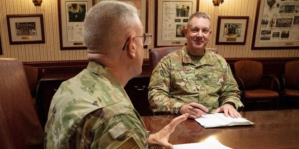 Brig. Gen. Robert Lyman (USAF), director, Command, Control, Communications, and Cyber Systems Directorate, TCJ6, pictured center, speaks to Col. Mark Bradley, USAF, the TCJ6 deputy director at the U.S. Transportation Command (USTRANSCOM) on June 9. In July, Gen. Lyman will be joining the Pentagon as the Air Force’s assistant deputy chief of staff for Cyber Effects Operations, AF A2/A6. Photo by Michelle Gigante, USTRANSCOM/PA