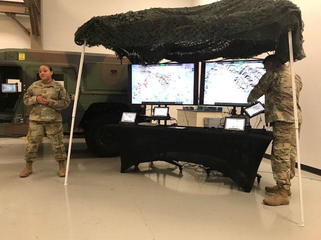 The Army’s SFC Sheena Ferrell (l) and SFC Ramon Contreras, both from the National Training Center, Fort Irwin, California, demonstrate the new Tactical Computing Environment developed by CERDEC.