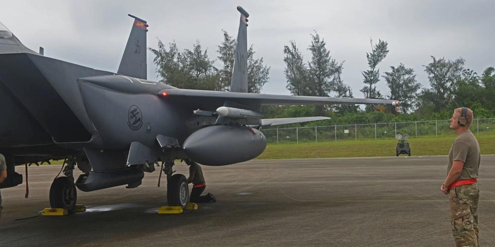 An airman from deployed from Mountain Home Air Force Base, Idaho, examines an F-15E Strike Eagle during preflight inspections at Tinian International Airport, Tinian during Pacific Iron 21 in August. To conduct such agile, more lethal movement of forces and airpower in the region, more software solutions are needed. Credit: U.S. Air Force photo by Tech. Sgt. Benjamin Sutton