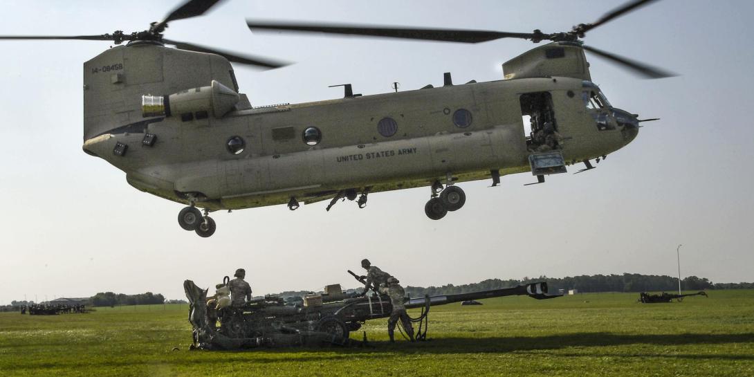 Soldiers with the 101st Airborne Division (Air Assault) use a Boeing CH-47 Chinook helicopter to slingload an M777 howitzer during air assault training at Fort Campbell, Kentucky. The 101st is experimenting with cloud computing for tailored command posts. Credit: Photo by: Sgt. Marcus Floyd
