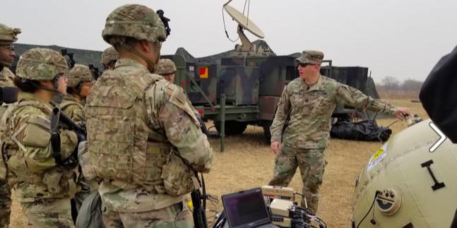 Capt. Zachary Schofield (center), USA, assistant product manager with Wideband Enterprise Satellite Systems, demonstrates an inflatable satellite antenna (ISA) to soldiers at Camp Humphreys, South Korea in 2019. The Army’s Communications Electronics Command (CECOM) has a global support program in place to ensure communications equipment readiness. Credit: Amburr Reese, CECOM Public Affairs