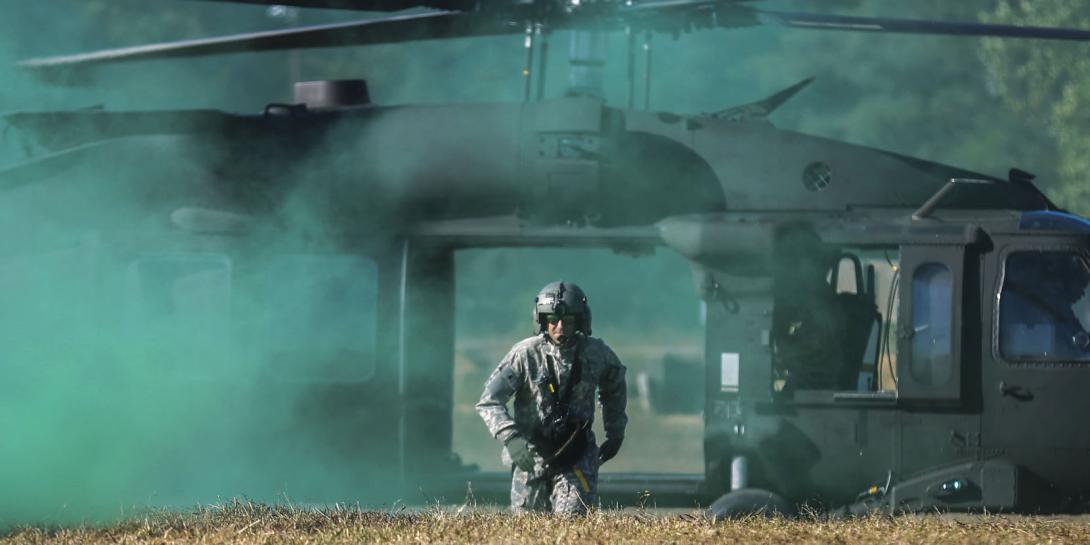 Army Staff Sgt. Nate Sanchez runs to assist a competitor during the Army Best Warrior Competition at Fort A.P. Hill, Virginia, on October 4. The Army is currently outlining plans to make its computer network more of a competitor on the battlefield. Army photo by Pfc. Miguel Pena