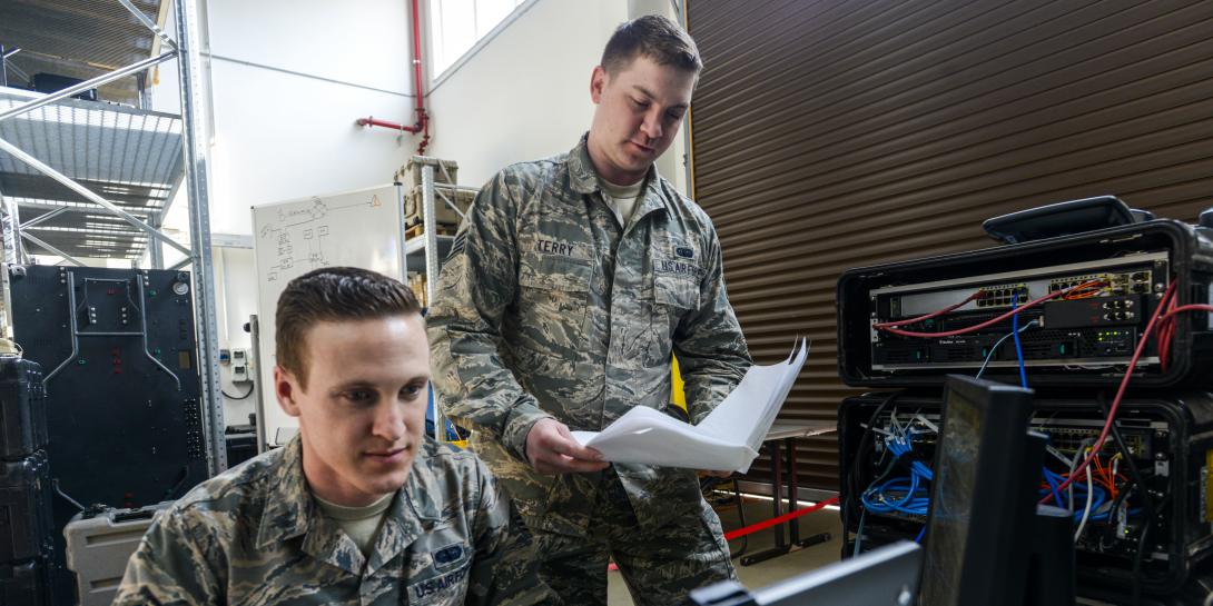 U.S. Airmen with the 1st Combat Communications Squadron review their systems against technical guides during a cybersecurity audit in March at Ramstein Air Base, Germany. Photo by Staff Sgt. Timothy Moore, USAF
