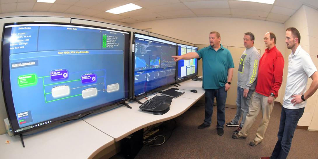 Engineers from the 517th Software Engineering Squadron, including (l-r) Carl Stuck and Scott Vigil, project directors; David Jolley, director; and Brent VanDerMeide, flight director, have created a new software development platform. U.S. Air Force photo by Todd Cromer