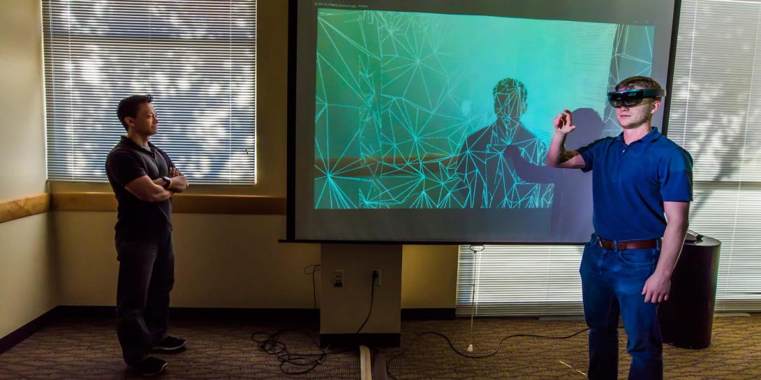 Tam Le (l) and Todd Noel, computer scientists at Sandia National Laboratories, demonstrate how augmented reality assists in nuclear material protection training.