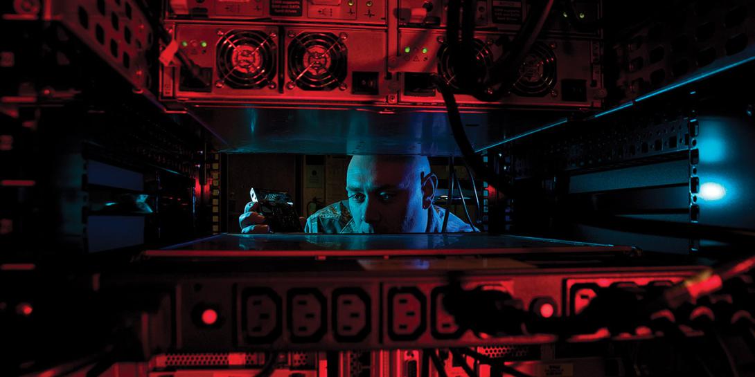 While preparing for a command cyber readiness inspection (CCRI), Staff Sgt. Jerome Duhan, USAF, a network administrator with the 97th Communications Squadron, inserts a hard drive into the network control center retina server at Altus Air Force Base, Oklahoma. Air Force photo by Senior Airman Franklin R. Ramos, USAF