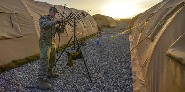 A U.S. Air Force tactical network operations technician adjusts an AV-211 antenna at Diyarbakir Air Base, Turkey. The latest networking techniques, such as software-defined wide area networks, may offer both budgetary and operational benefits for the Defense Department.