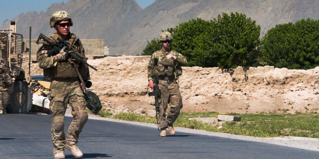 Two U.S. soldiers prepare to clear improvised explosive devices (IEDs) from a polling area in Afghanistan. Many of the processes the Joint Improvised-Threat Defeat Agency (JIDA) uses to bring useful technologies and systems to the field quickly can be applied to acquisition reform efforts throughout the U.S. Defense Department.