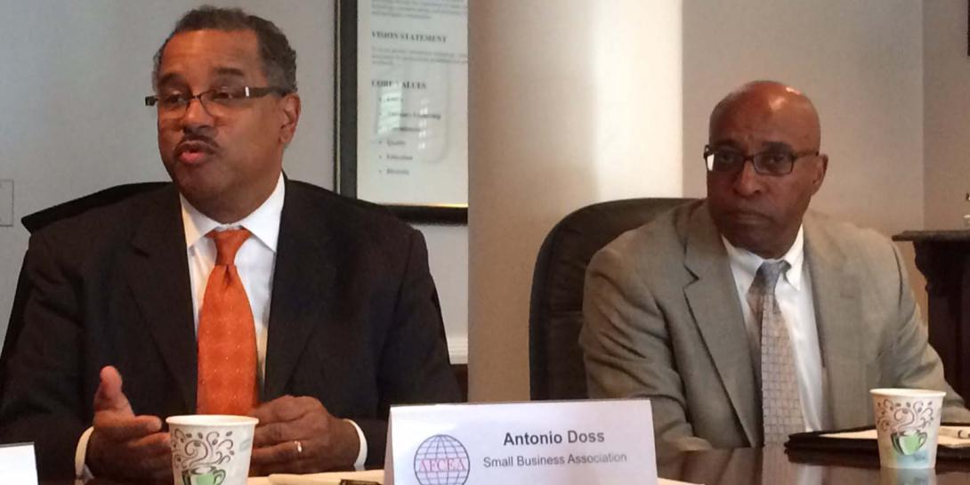 Antonio Doss (l), district director of the SBA’s Washington Metropolitan Area District Office, talks about a major rule change during AFCEA's Small Business Committee meeting.