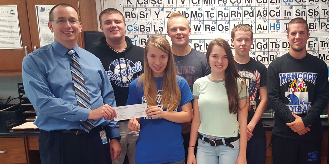 STEM teacher Ray Johnston and his Chem-Science Club students at Hancock Middle/Senior High School in Maryland show his $1,000 Gravely Grant.