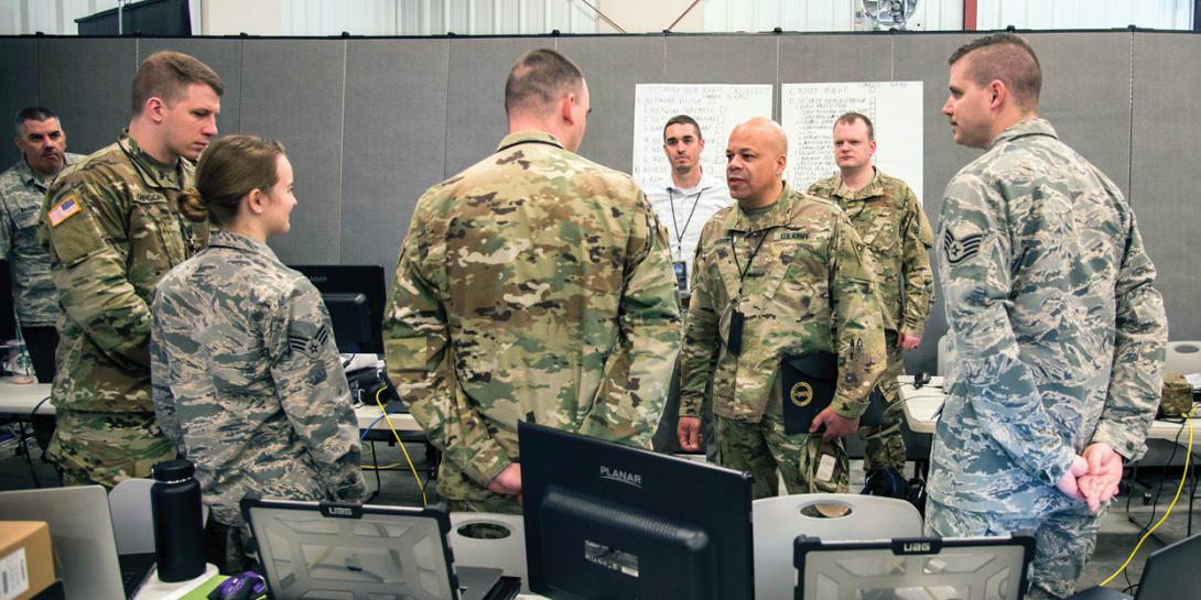 Maj. Gen John C. Harris Jr., ANG (c), the adjutant general, Ohio National Guard, observes training while the Cyber Mission Assurance Team (CMAT) conducts network assessments during exercise week of Cyber Shield 19 at Camp Atterbury, Indiana. The National Guard is standing up the teams to help secure the critical infrastructure that services U.S. Defense Department installations. U.S. Army National Guard Photo by Staff Sgt. George B. Davis