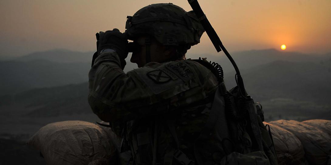 A U.S. Army staff sergeant observes the area around Forward Operating Base Torkham, Afghanistan, while wearing a new communications suite. The Communications and Human Networks program strives to improve mobile ad hoc networking for future warfighters.