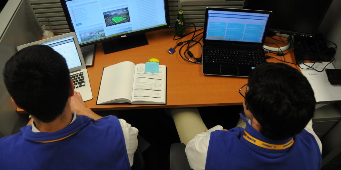 Interns Jose Cantu, left, a student at Georgetown University and Scott Jaster, a student at Dartmouth College help monitor for threats at Super Bowl 50.