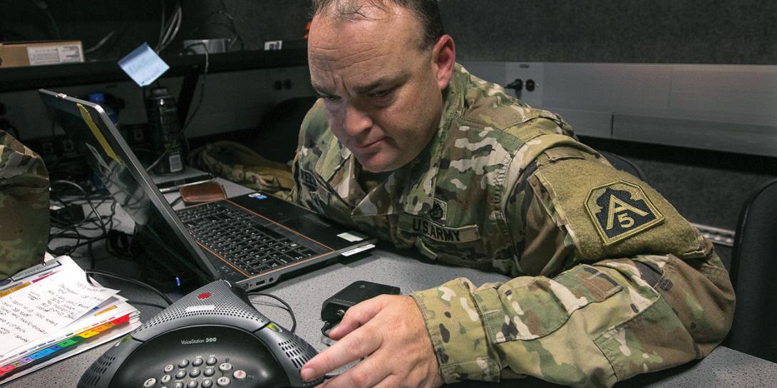 Lt. Col. Johnpaul Kelly, USA, an operations officer assigned to U.S. Army North, participates in a conference call with unit leadership in Hempstead, Texas, as the U.S. Defense Department conducts Defense Support of Civil Authorities operations in response to the effects of Hurricane Harvey. U.S. Army photo by Spc. Dustin D. Biven, USA