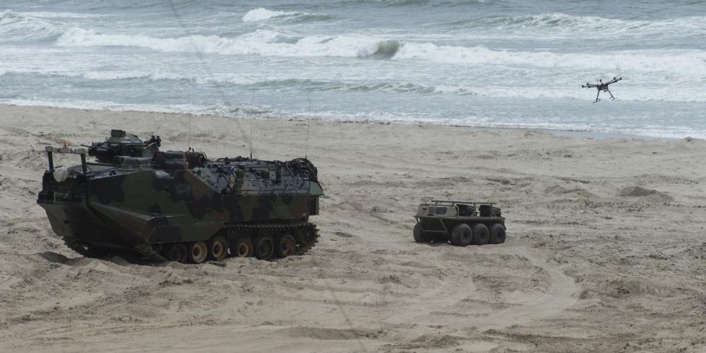An unmanned aerial vehicle launches from a multi-utility tactical transport vehicle after exiting an autonomous amphibious assault vehicle during Ship-to-Shore Maneuver Exploration and Experimentation Advanced Naval Technology Exercise 2017. U.S. Navy photo by John F. Williams