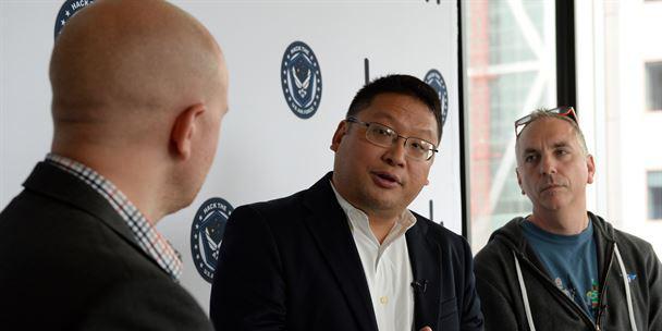 Alex Rice, chief technology officer and co-founder of HackerOne Incorporated (l), speaks with Peter Kim, Air Force chief information security officer (c), and Chris Lynch, director, Defense Digital Service, about the upcoming Hack the Air Force event.