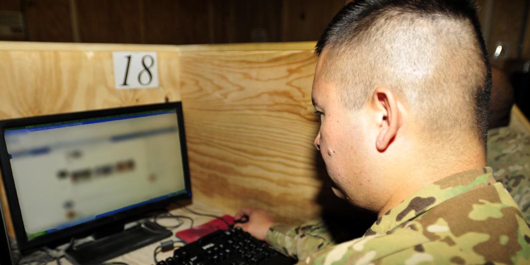 A U.S. soldier talks with his wife on Facebook at an Internet cafe set up at Kandahar Airfield in Afghanistan.