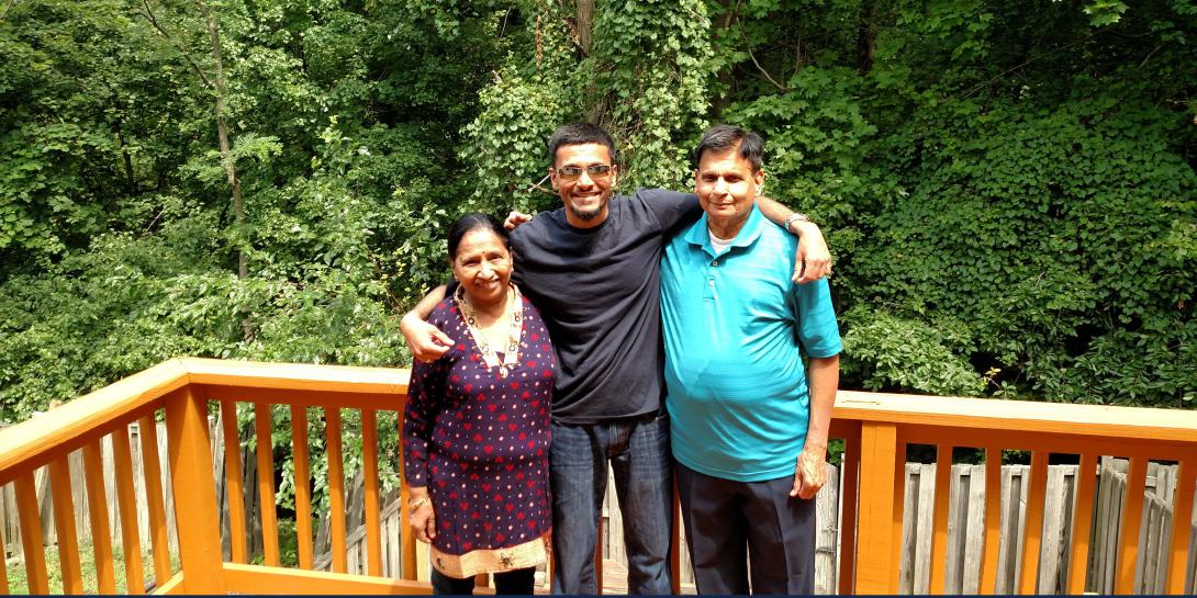 Nischit Vaidya (c), stands with his mother Mira Vaidya and father Niranjan Vaidya. Vaidya started a scholarship in his parents' names for cyber students at Capitol Technology University. Two students, a male and a female, will receive $1,000 each this fall. Photo courtesy Nischit Vaidya.