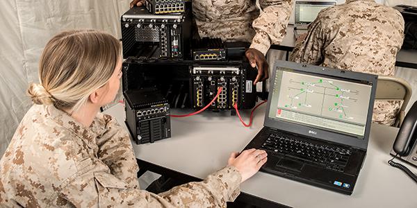 The military wants smaller, lighter and ruggedized servers, routers and other equipment that contain cybersecurity measures in order to take their networks into battle. Here, soldiers are taking a look at the PacStar Tactical Fidelis Cybersecurity System. Photo Credit: Pacific Star Communications.