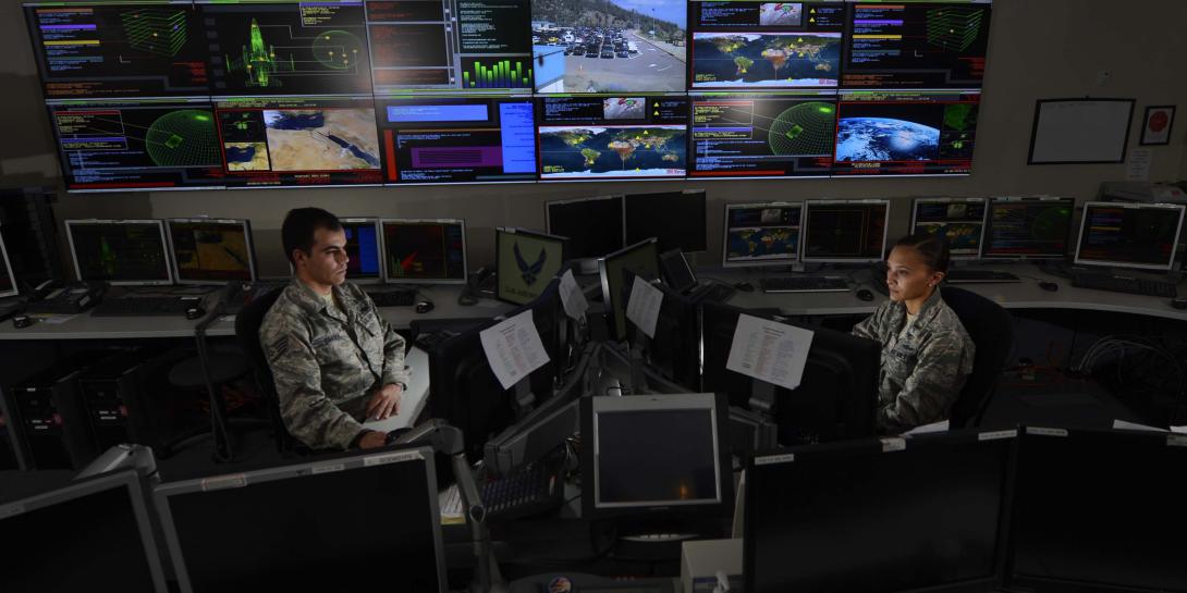 Two U.S. Air Force space and cyber airmen work in the Global Strategic Warning and Space Surveillance Systems Center at Cheyenne Mountain Air Force Station, Colorado. The Air Force aims to change the nature of its cyber work force as it transitions deeper into the information age.