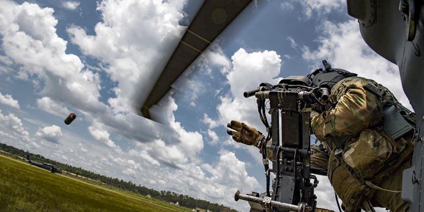 Technical Sgt. Brandon Middleton, USAF, tosses a smoke grenade from an HH-60G Pave Hawk helicopter during training at Moody Air Force Base, Georgia, in June. Increased real-time battlefield data, improved processing capabilities and the need for rapid action call for the increased use of agile software development.