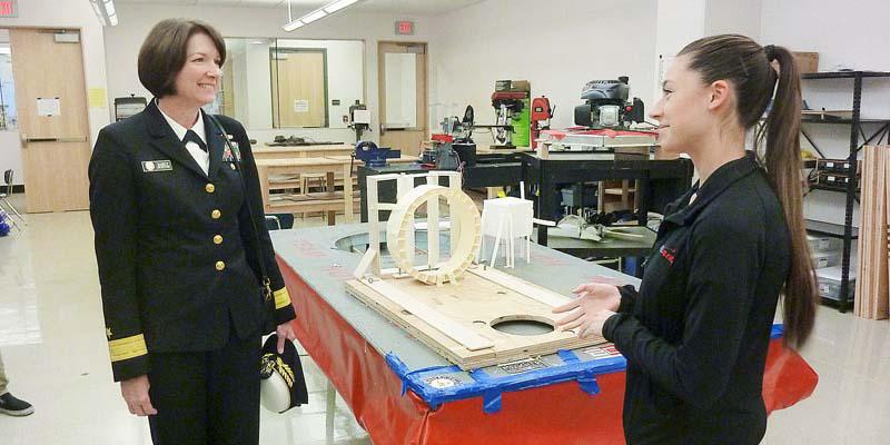 A high school student explains her team's hovercraft project to Rear Adm. Nancy Norton, USN, while Norton visits the Engineering and Aerospace Sciences Academy (EASA) in McMinnville, Oregon.