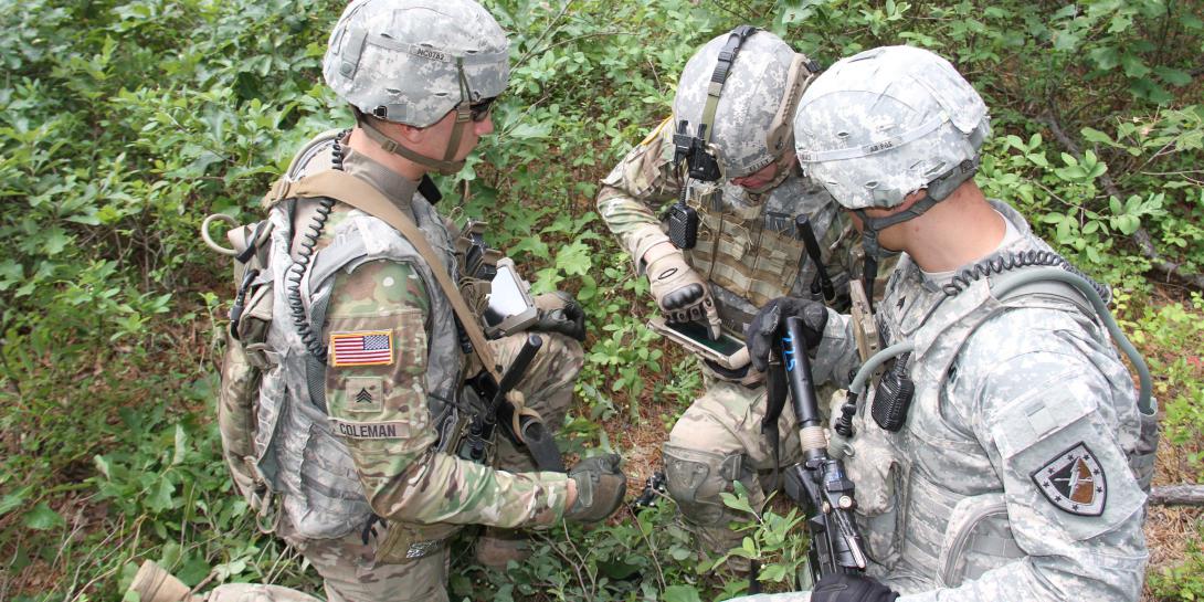 Soldiers from the Fort Benning, Georgia, Experimental Force, Alpha Company, 1st Battalion, 29th Infantry Regiment, assess capabilities on mobile devices during a field-based risk-reduction event at Joint Base McGuire-Dix-Lakehurst in New Jersey.