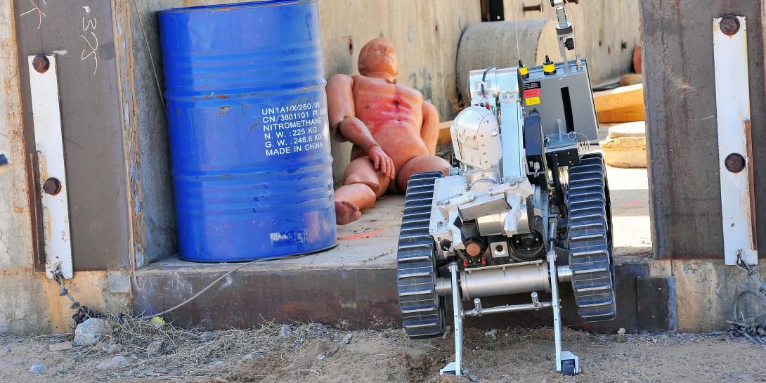 A robot performs a rescue operation on a dummy victim during a training exercise at a previous Robot Rodeo. (Photo by Randy Montoya)