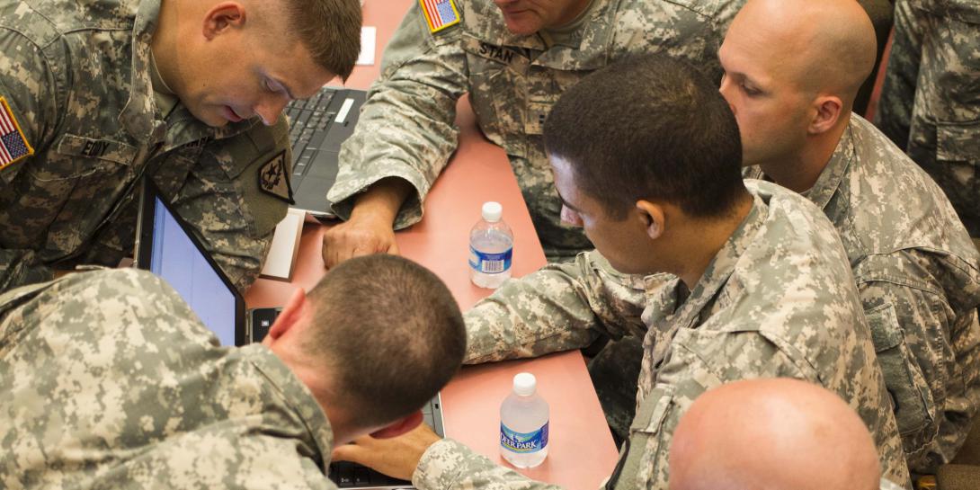 Gathering around a single laptop, soldiers from Team National Guard map out a strategy to win the U.S. Army’s Cyber Center of Excellence’s multiservice NetWar competition in 2014. The exercise was created to build the cyber operators’ capabilities in the new warfighting domain.