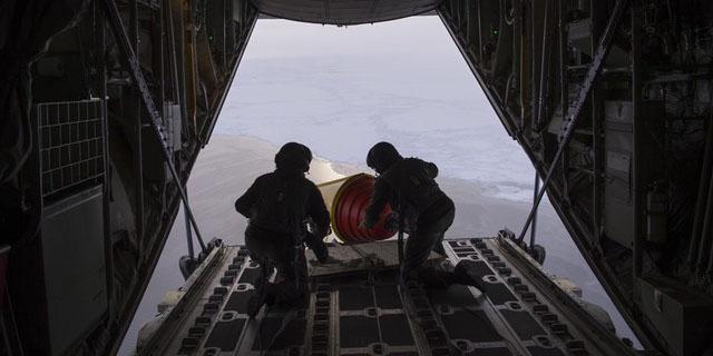 One way international military and government agencies gather information about weather and oceanographic data to enhance forecasting and environmental models is through networked buoys. The Royal Danish Air Force deployed these ice-hardened buoys from a C-130 into the Arctic Ocean in September as part of the International Arctic Buoy Program. Credit: John F. Williams