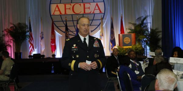 Lt. Gen. Alan R. Lynn, USA, director, Defense Information Systems Agency and commander, Joint Force Headquarters, Department of Defense Information Network, gives the keynote luncheon address amidst attendees at Defensive Cyber Operations Symposium 2016 in Washington, D.C.