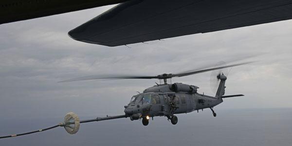 An HH-60G Pave Hawk assigned to the 33rd Rescue Squadron performs helicopter air-to-air refueling with an MC-130J Commando II from the 17th Special Operations Squadron above the Pacific Ocean during Exercise Westpac Rumrunner. (Photo by Staff Sgt. Benjamin Sutton)