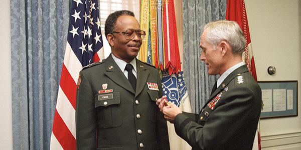 Gen. John A. Wickham Jr., USA (Ret.), then Army chief of staff (r), presents the U.S. Army's Distinguished Service Medal to Lt. Gen. Emmett Paige Jr., USA (Ret.), then commander, U.S. Army Information Systems Command, during a 1986 ceremony at the Pentagon. (Defense Department photo by Scott Davis)