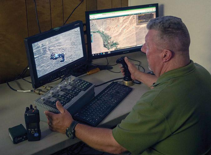 Aerostat camera operator John Webb monitors video feeds from an aerostat during NATO’s Unified Vision 18 at the Yuma Proving Ground, Arizona. The aerostat provides 24-hour surveillance of the battlespace to improve security and information for ground troops. Unified Vision is a biannual trial designed to ensure that joint intelligence, surveillance and reconnaissance assets from NATO and the allies can operate together to counter security challenges. NATO photo by Chief Petty Officer Adrian Melendez, USN