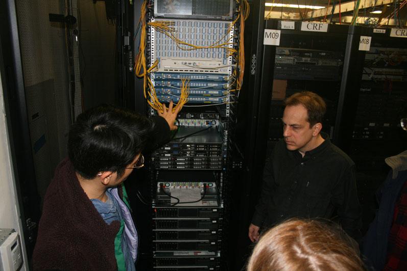 Along with computer servers and routers, optical network equipment, supplied to the COSMOS testbed by the University of Arizona, provides fast connectivity between edge cloud computing and radio nodes, explains Tingjun Chen (l), a Columbia University doctoral student, and his professor, Gil Zussman.