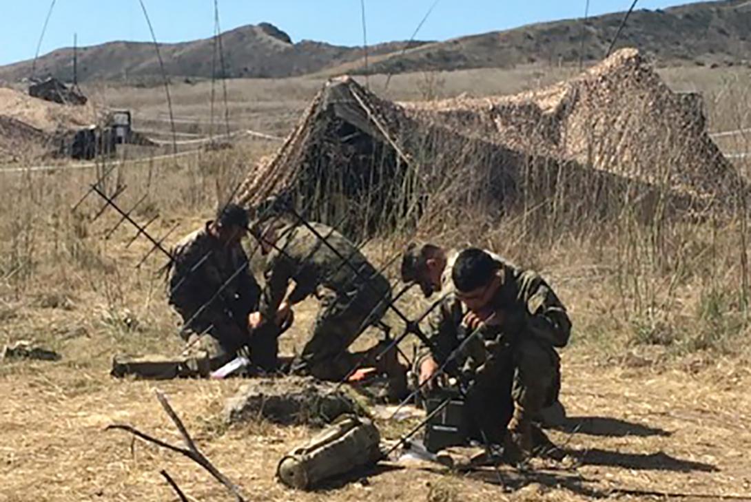 U.S. Marines from the 1st Marine Division test the Mobile User Objective Systems, a satellite communication (SATCOM) capability that uses commercial cellphone technology to increase access to communications on the battlefield.