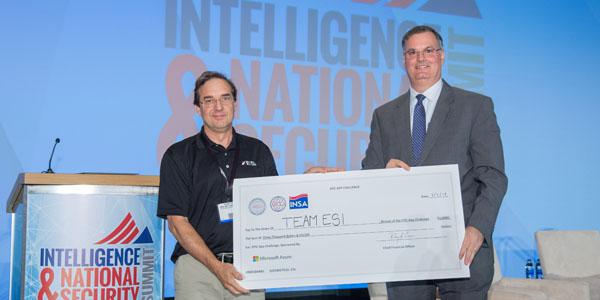 Jim Cannaliato of Engineering Solutions Inc. (l) receives a $3,000 check for his company’s winning entry in the EPIC App challenge. Presenting the check is AFCEA Intelligence Committee member Joe Schmank of Microsoft Azure Government Cloud.