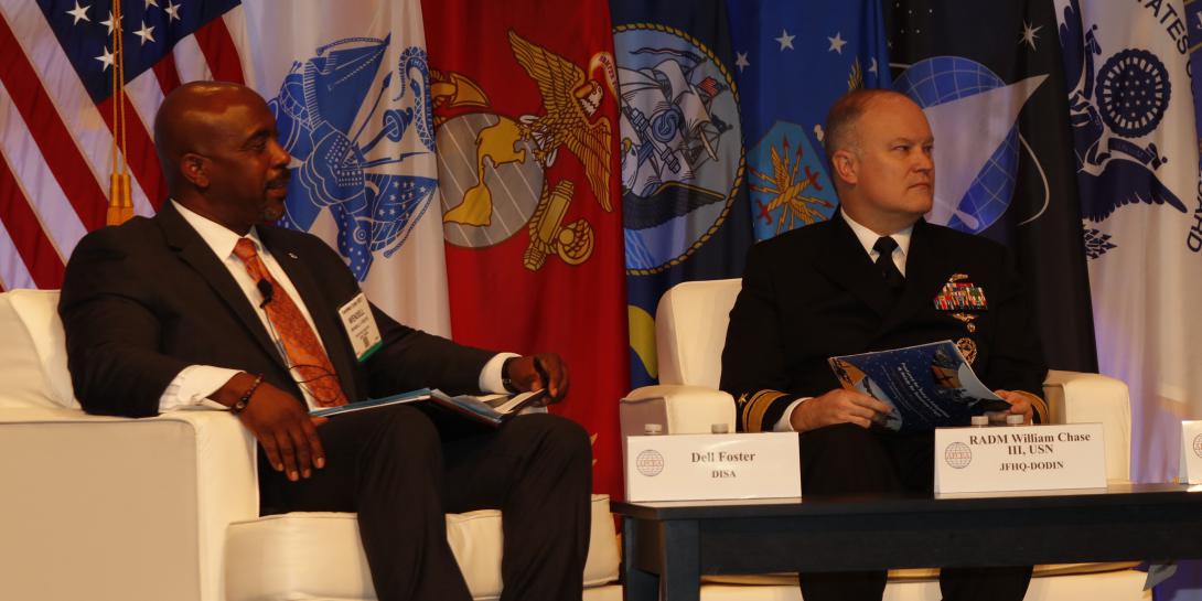 Wendell E. Foster, Jr., executive director, DODIN (l), and Rear Adm. William E. Chase III, USN, deputy commander, JFHQ-DODIN, talk about the past, present and future of JFHQ-DODIN during TechNet Cyber. Photo by Michael Carpenter